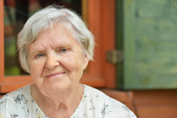 Senior woman on the veranda of his home.