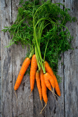 fresh carrots on wooden background