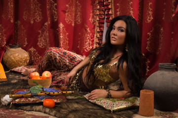 Beautiful woman in the arabic harem interior