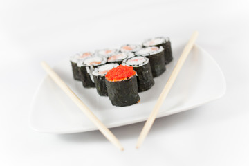 Sushi menu and chopsticks on plate, white background