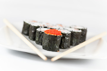 Sushi menu and chopsticks on plate, white background