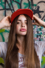 big natural lips female model posing on graffiti