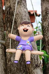 statuettes of happy boy on the swing