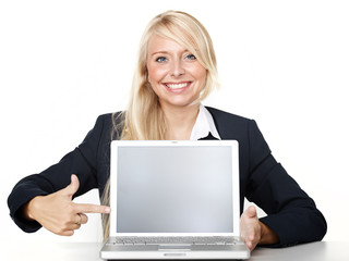 Business woman pointing at her laptop with copyspace