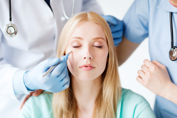 Fototapeta premium plastic surgeon and nurse with patient