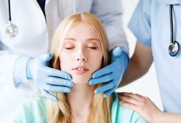 Naklejka premium plastic surgeon or doctor with patient