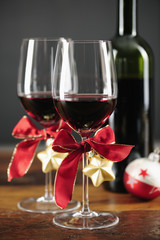 Two glasses of red wine with christmas ornaments