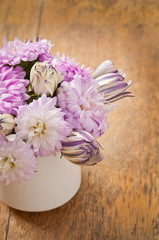 Beautiful aster flower bouquet on wooden table
