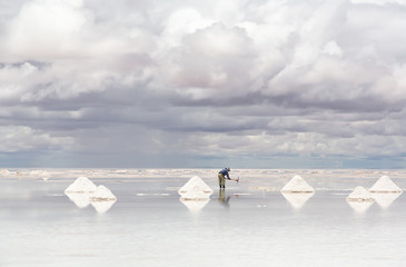 Worker performing harvesting salt on Salar de Uyuni