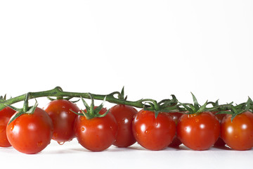 Tomatoes on white background, and wood