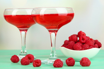 Jelly with fresh berries on green wooden table