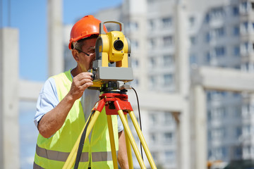 worker with theodolite