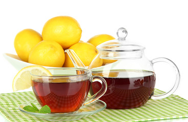 Cup of tea with lemon on table on white background