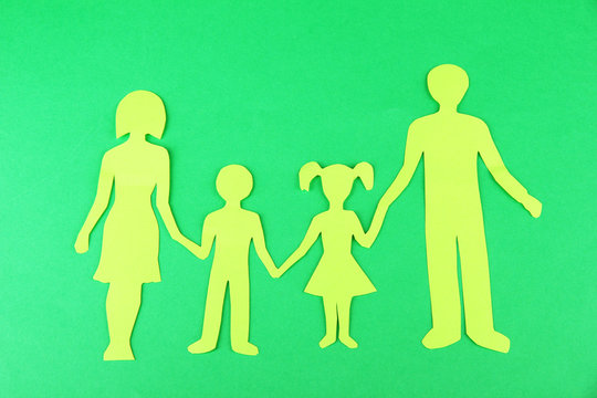 Family from paper on bright background