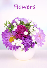 Beautiful bouquet of bright flowers in vase on bright