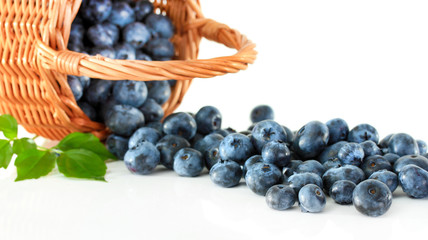 Blueberries in wooden basket isolated on white