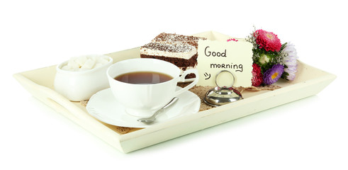 Cup of tea with cakes on wooden tray isolated on white
