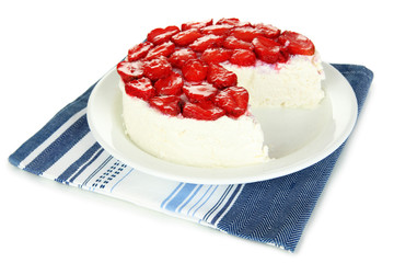Cheesecake with fresh berries on white plate closeup