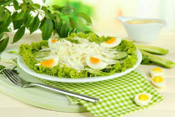 Delicious salad with eggs, cabbage and cucumbers on wooden
