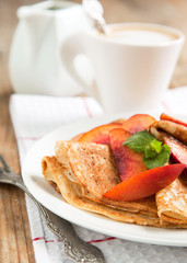 Crepes with fresh peaches for breakfast