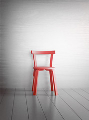 Empty single chair against wall