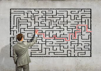 Businessman solving labyrinth problem
