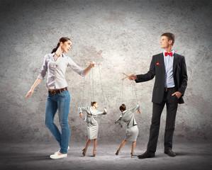 Businesspeople with marionettes