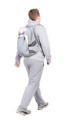 back view of walking  man  with backpack.