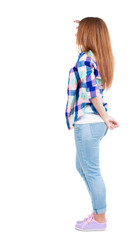 back view of standing young beautiful redhead woman.
