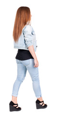 Obraz premium back view of walking woman.