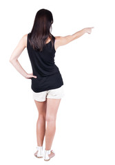 Fototapeta premium Back view of pointing woman.