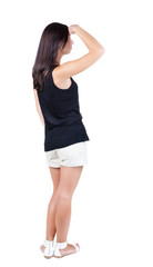 Fototapeta premium back view of standing young beautiful brunette woman.