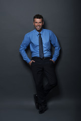 Relaxed and confident businessman looking at camera