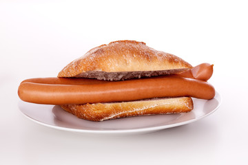 Bun with wieners on the plate