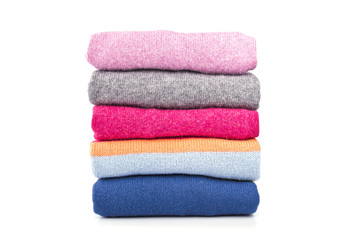 a stack of woolen jumpers