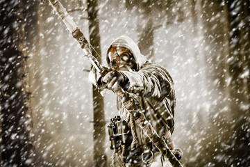 A male bow hunter in a forest