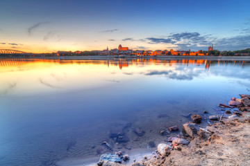 Torun old town reflected in Vistula river at sunset, Poland © Patryk Kosmider