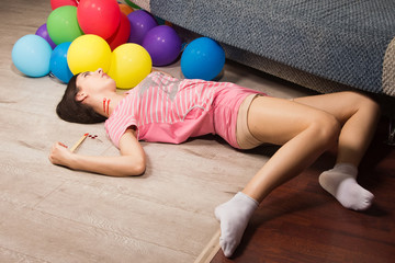 Lifeless woman lying on the floor (imitation)