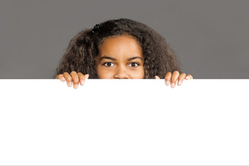 Girl looking over white Wall