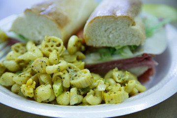 Pasta Salad with Sub Sandwich in Background