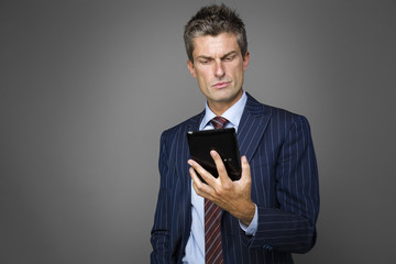 Portrait of elegant pensive businessman watching news