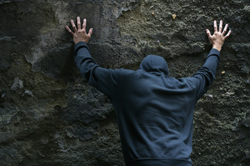 Arrested bandit with their hands up.