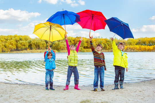Boys and girls holding umbrellas
