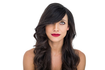 Pretty dark haired woman posing with red lips looking up