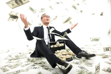 I am rich! Happy young businessman in formalwear throwing money