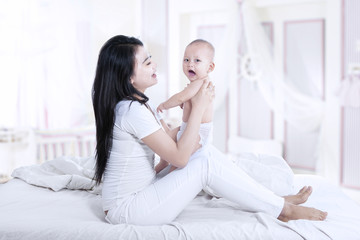 Beautiful mother and baby at home