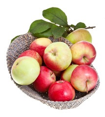 Naklejka na ściany i meble red and yellow apples in straw basket isolated