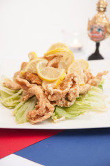 Deep fried chicken with honey and lemon sauce.