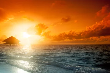 Poster Sunset on Maldives island, water villas resort © fotomaximum