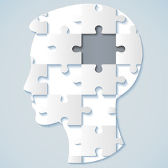 Image of a human face in the form of a jigsaw puzzle with a gray